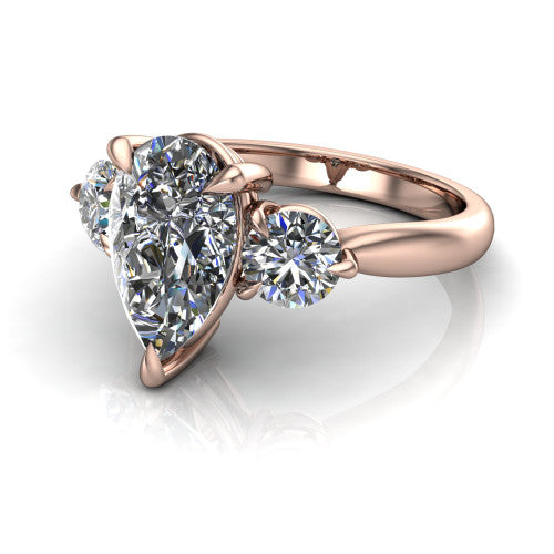 Juniper pear three stone engagement ring in 18K Rose Gold, three-quarter perspective showing the brilliant pear-cut center diamond flanked by two round side diamonds on a rounded plain band