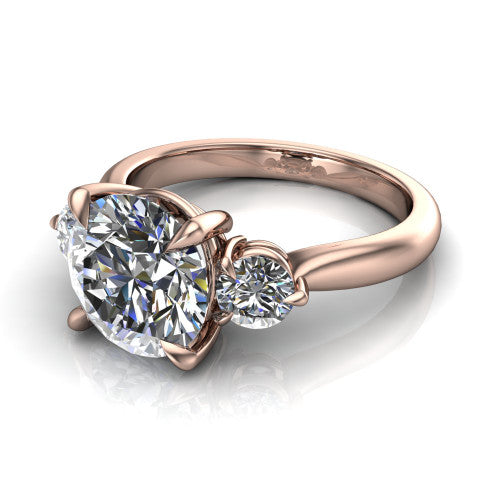 Juniper round three stone engagement ring in 18K Rose Gold, three-quarter perspective showing the brilliant round center diamond flanked by two round side diamonds on a rounded plain band
