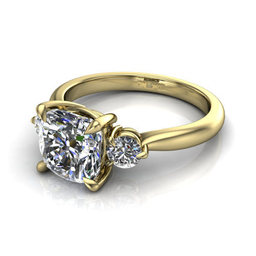 Juniper cushion three stone engagement ring in 18K Yellow Gold, three-quarter perspective showing the brilliant cushion-cut center diamond flanked by two round side diamonds on a rounded plain band