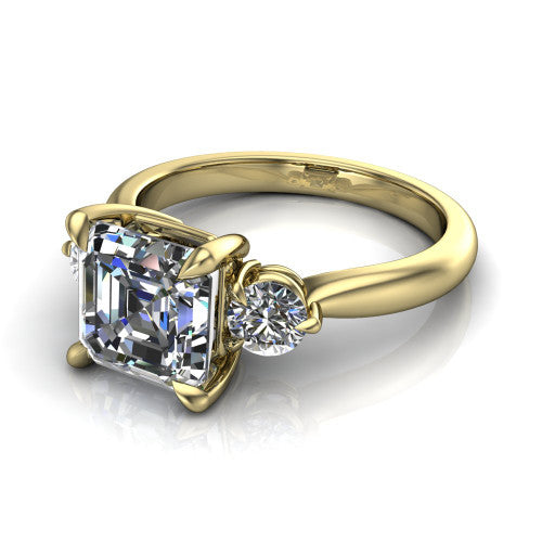 Juniper square emerald three stone engagement ring in 14K Yellow Gold, three-quarter perspective showing the step-cut square emerald center diamond flanked by two round side diamonds on a rounded plain band
