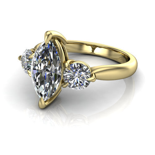 Juniper marquise three stone engagement ring in 18K Yellow Gold, three-quarter perspective showing the brilliant marquise center diamond flanked by two round side diamonds on a rounded plain band