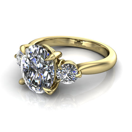 Juniper oval three stone engagement ring in 18K Yellow Gold, three-quarter perspective showing the brilliant oval center diamond flanked by two round side diamonds on a rounded plain band