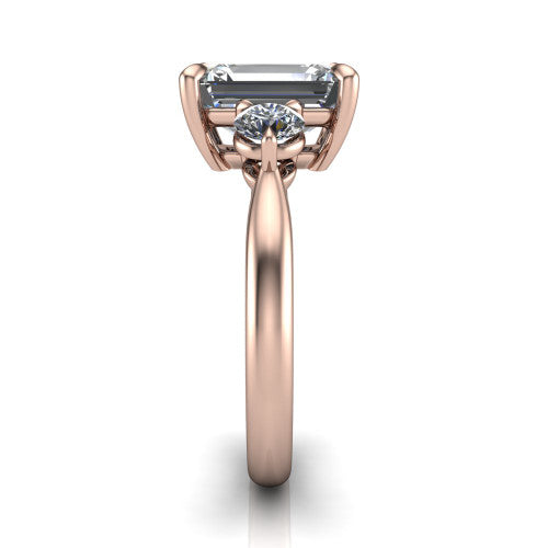 Juniper emerald three stone engagement ring in 18K Rose Gold, side profile showing the three-stone head and slim rounded polished band