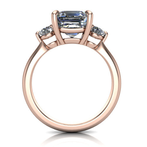 Juniper square emerald three stone engagement ring in 14K Rose Gold, through-finger front profile showing the three-stone head and clean open under-gallery