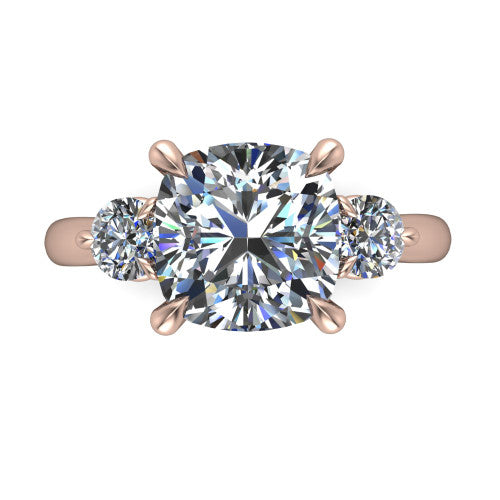 Juniper cushion three stone engagement ring in 14K Rose Gold, top-down view showing the brilliant cushion-cut center diamond with two matched round side diamonds