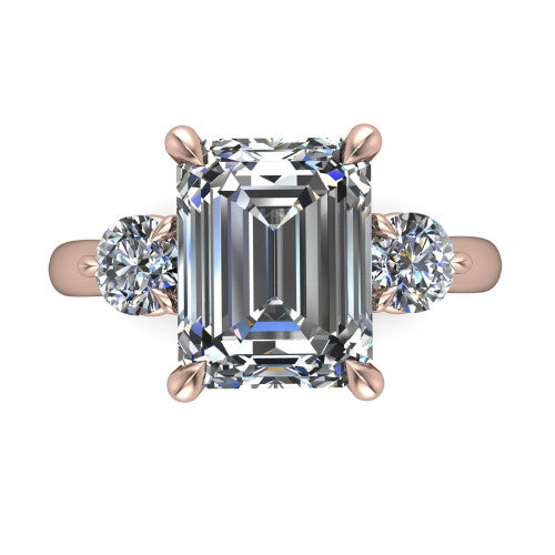 Juniper emerald three stone engagement ring in 18K Rose Gold, top-down view showing the step-cut emerald center diamond with two matched round side diamonds