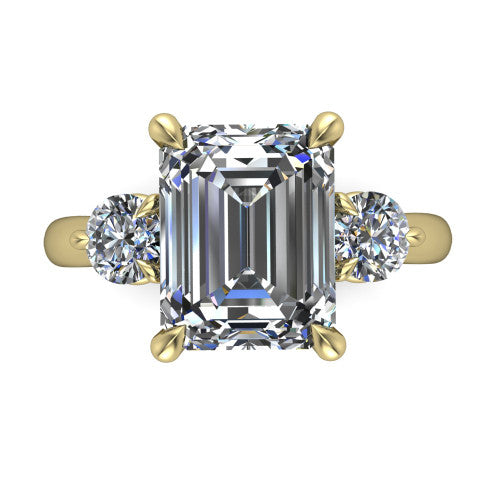 Juniper emerald three stone engagement ring in 14K Yellow Gold, top-down view showing the step-cut emerald center diamond with two matched round side diamonds