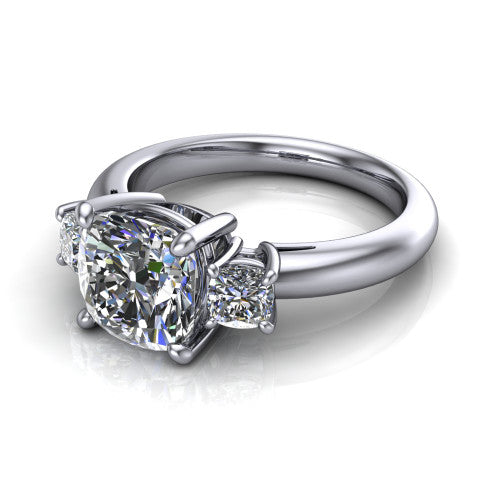 Penelope cushion three stone engagement ring in Platinum, three-quarter perspective showing the brilliant cushion-cut center diamond, two matched cushion-cut side diamonds