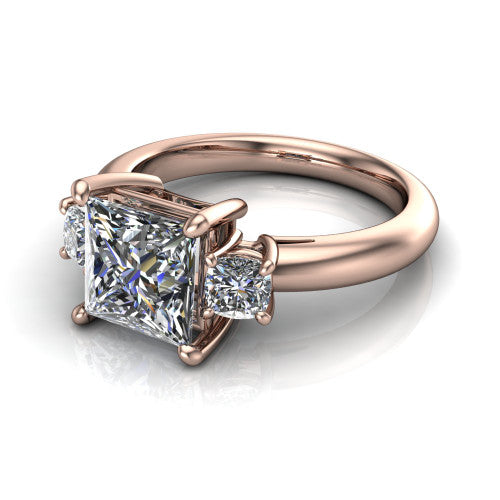 Penelope princess three stone engagement ring in 18K Rose Gold, three-quarter perspective showing the brilliant princess-cut center diamond, two matched princess-cut side diamonds