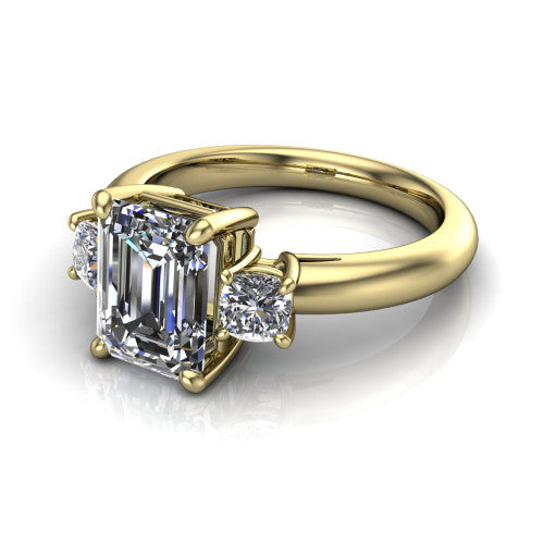 Penelope emerald three stone engagement ring in 14K Yellow Gold, three-quarter perspective showing the step-cut emerald center diamond, two matched step-cut emerald side diamonds