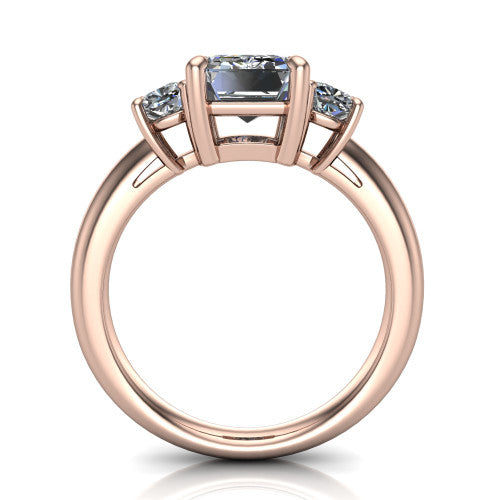 Penelope emerald three stone engagement ring in 18K Rose Gold, through-finger front profile showing the three-stone head, tall basket, and open under-gallery