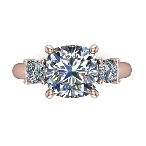 Penelope cushion three stone engagement ring in 18K Rose Gold, top-down view showing the brilliant cushion-cut center diamond, two matched cushion-cut side diamonds aligned across the band