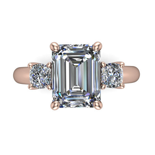 Penelope emerald three stone engagement ring in 14K Rose Gold, top-down view showing the step-cut emerald center diamond, two matched step-cut emerald side diamonds aligned across the band
