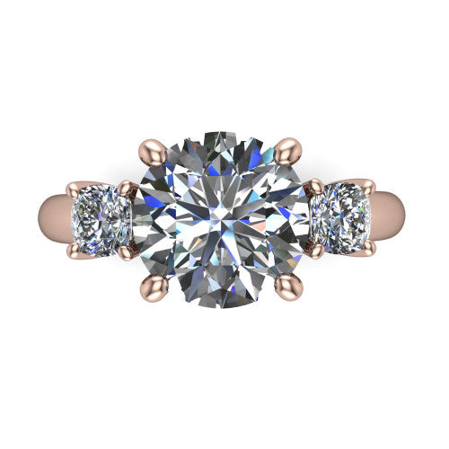 Penelope round three stone engagement ring in 18K Rose Gold, top-down view showing the brilliant round center diamond, two matched round side diamonds aligned across the band
