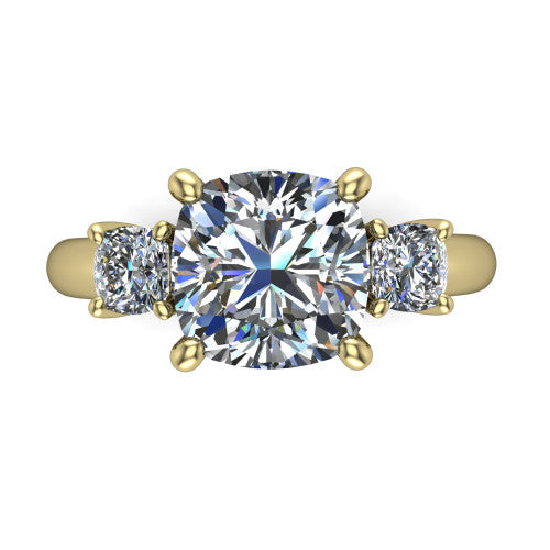 Penelope cushion three stone engagement ring in 14K Yellow Gold, top-down view showing the brilliant cushion-cut center diamond, two matched cushion-cut side diamonds aligned across the band