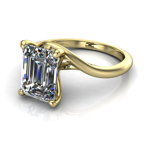 Awren emerald solitaire engagement ring in 18K Yellow Gold, three-quarter perspective showing the step-cut emerald center diamond on a bypass crossover shank