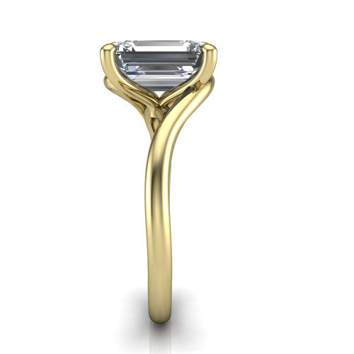 Awren emerald solitaire engagement ring in 18K Yellow Gold, side profile showing the bypass crossover shank and slim polished band