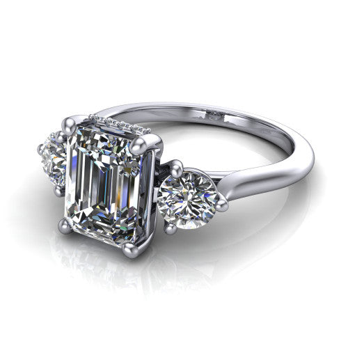 Edith emerald hidden halo engagement ring in 14K White Gold, three-quarter perspective showing the step-cut emerald center diamond flanked by two round side diamonds with a hidden pave halo beneath the center stone