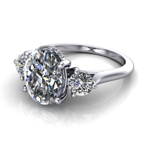 Edith oval hidden halo engagement ring in 18K White Gold, three-quarter perspective showing the brilliant oval center diamond flanked by two round side diamonds with a hidden pave halo beneath the center stone