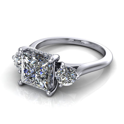 Edith princess hidden halo engagement ring in 14K White Gold, three-quarter perspective showing the brilliant princess-cut center diamond flanked by two round side diamonds with a hidden pave halo beneath the center stone