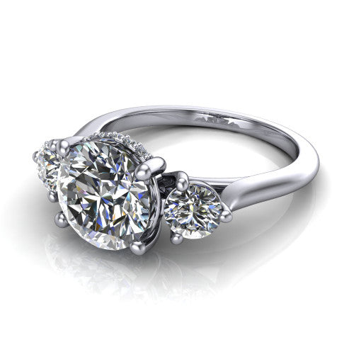 Edith round hidden halo engagement ring in Platinum, three-quarter perspective showing the brilliant round center diamond flanked by two round side diamonds with a hidden pave halo beneath the center stone