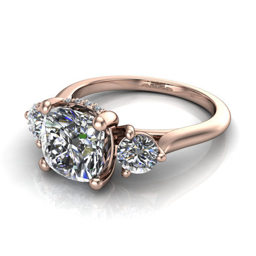 Edith cushion hidden halo engagement ring in 18K Rose Gold, three-quarter perspective showing the brilliant cushion-cut center diamond flanked by two round side diamonds with a hidden pave halo beneath the center stone