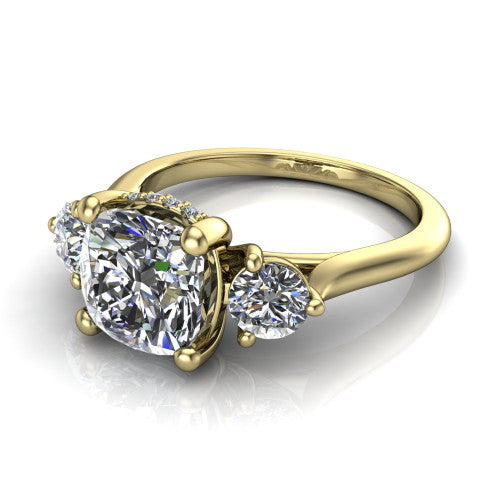 Edith cushion hidden halo engagement ring in 18K Yellow Gold, three-quarter perspective showing the brilliant cushion-cut center diamond flanked by two round side diamonds with a hidden pave halo beneath the center stone