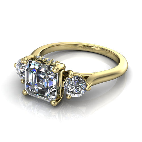 Edith square emerald hidden halo engagement ring in 18K Yellow Gold, three-quarter perspective showing the step-cut square emerald center diamond flanked by two round side diamonds with a hidden pave halo beneath the center stone