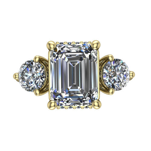 Edith emerald hidden halo engagement ring in 14K Yellow Gold, top-down view showing the step-cut emerald center diamond with two matched round side diamonds and the hidden pave halo peeking from beneath