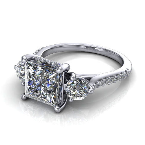 Phoebe princess hidden halo engagement ring in Platinum, three-quarter perspective showing the center diamond between two round side stones above a pav&eacute; shank