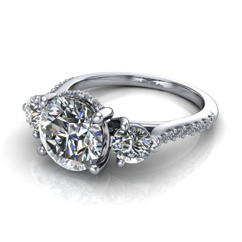 Phoebe round hidden halo engagement ring in Platinum, three-quarter perspective showing the center diamond between two round side stones above a pav&eacute; shank