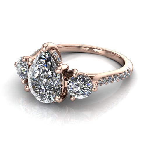 Phoebe pear hidden halo engagement ring in 14K Rose Gold, three-quarter perspective showing the center diamond between two round side stones above a pav&eacute; shank