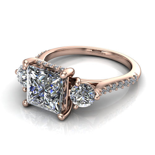 Phoebe princess hidden halo engagement ring in 14K Rose Gold, three-quarter perspective showing the center diamond between two round side stones above a pav&eacute; shank