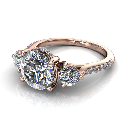 Phoebe round hidden halo engagement ring in 14K Rose Gold, three-quarter perspective showing the center diamond between two round side stones above a pav&eacute; shank
