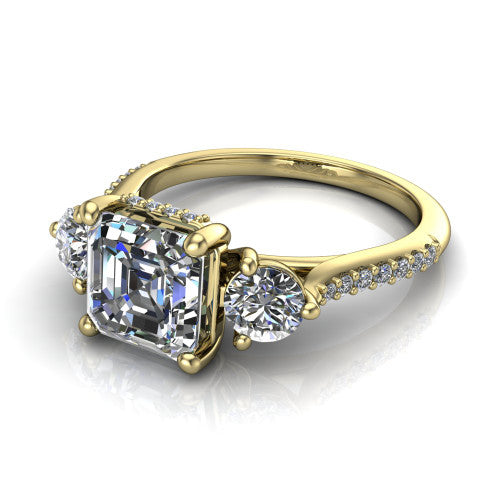 Phoebe asscher hidden halo engagement ring in 18K Yellow Gold, three-quarter perspective showing the center diamond between two round side stones above a pav&eacute; shank