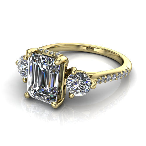 Phoebe emerald hidden halo engagement ring in 14K Yellow Gold, three-quarter perspective showing the center diamond between two round side stones above a pav&eacute; shank