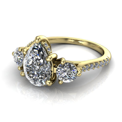 Phoebe pear hidden halo engagement ring in 18K Yellow Gold, three-quarter perspective showing the center diamond between two round side stones above a pav&eacute; shank