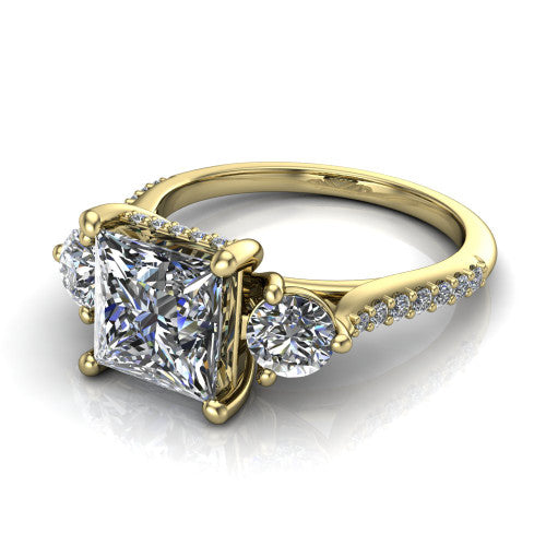 Phoebe princess hidden halo engagement ring in 18K Yellow Gold, three-quarter perspective showing the center diamond between two round side stones above a pav&eacute; shank
