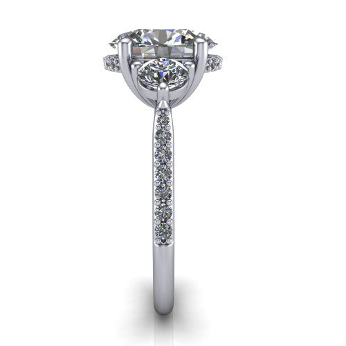 Phoebe oval hidden halo engagement ring in Platinum, side profile showing the hidden halo beneath the center and the pav&eacute; diamonds down the shank