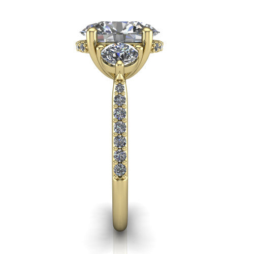 Phoebe oval hidden halo engagement ring in 14K Yellow Gold, side profile showing the hidden halo beneath the center and the pav&eacute; diamonds down the shank