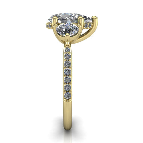 Phoebe pear hidden halo engagement ring in 14K Yellow Gold, side profile showing the hidden halo beneath the center and the pav&eacute; diamonds down the shank
