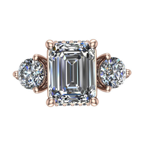 Phoebe emerald hidden halo engagement ring in 14K Rose Gold, top-down view showing the center diamond flanked by two round side stones over a hidden halo