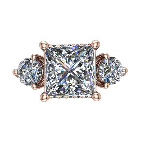 Phoebe princess hidden halo engagement ring in 14K Rose Gold, top-down view showing the center diamond flanked by two round side stones over a hidden halo