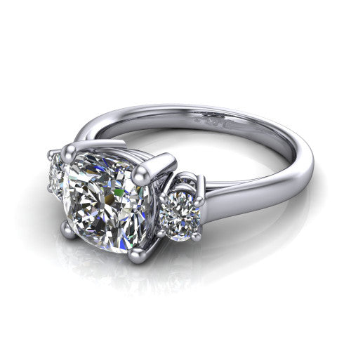 Imogen cushion three stone engagement ring in 18K White Gold, three-quarter perspective showing the center diamond between two round side stones on a slim polished band