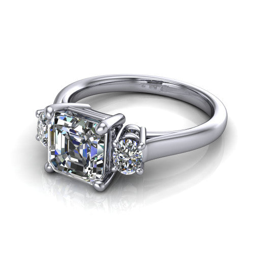 Imogen asscher three stone engagement ring in 14K White Gold, three-quarter perspective showing the center diamond between two round side stones on a slim polished band