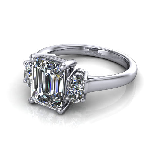 Imogen emerald three stone engagement ring in 14K White Gold, three-quarter perspective showing the center diamond between two round side stones on a slim polished band