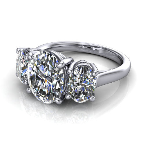 Imogen oval three stone engagement ring in 18K White Gold, three-quarter perspective showing the center diamond between two round side stones on a slim polished band