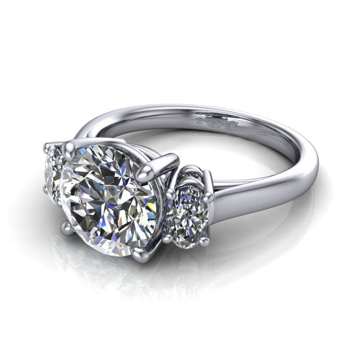 Imogen round three stone engagement ring in 18K White Gold, three-quarter perspective showing the center diamond between two round side stones on a slim polished band