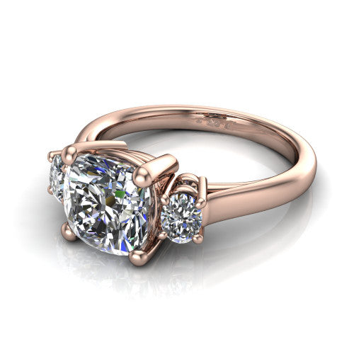 Imogen cushion three stone engagement ring in 14K Rose Gold, three-quarter perspective showing the center diamond between two round side stones on a slim polished band