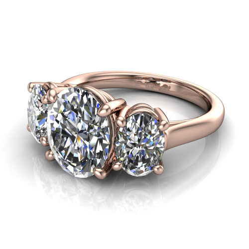 Imogen oval three stone engagement ring in 14K Rose Gold, three-quarter perspective showing the center diamond between two round side stones on a slim polished band